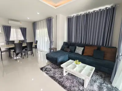 Spacious modern living room with elegant decor and ample natural light.