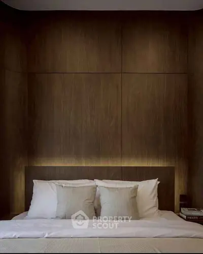 Luxurious bedroom with elegant wood paneling and plush bedding, perfect for relaxation and comfort.