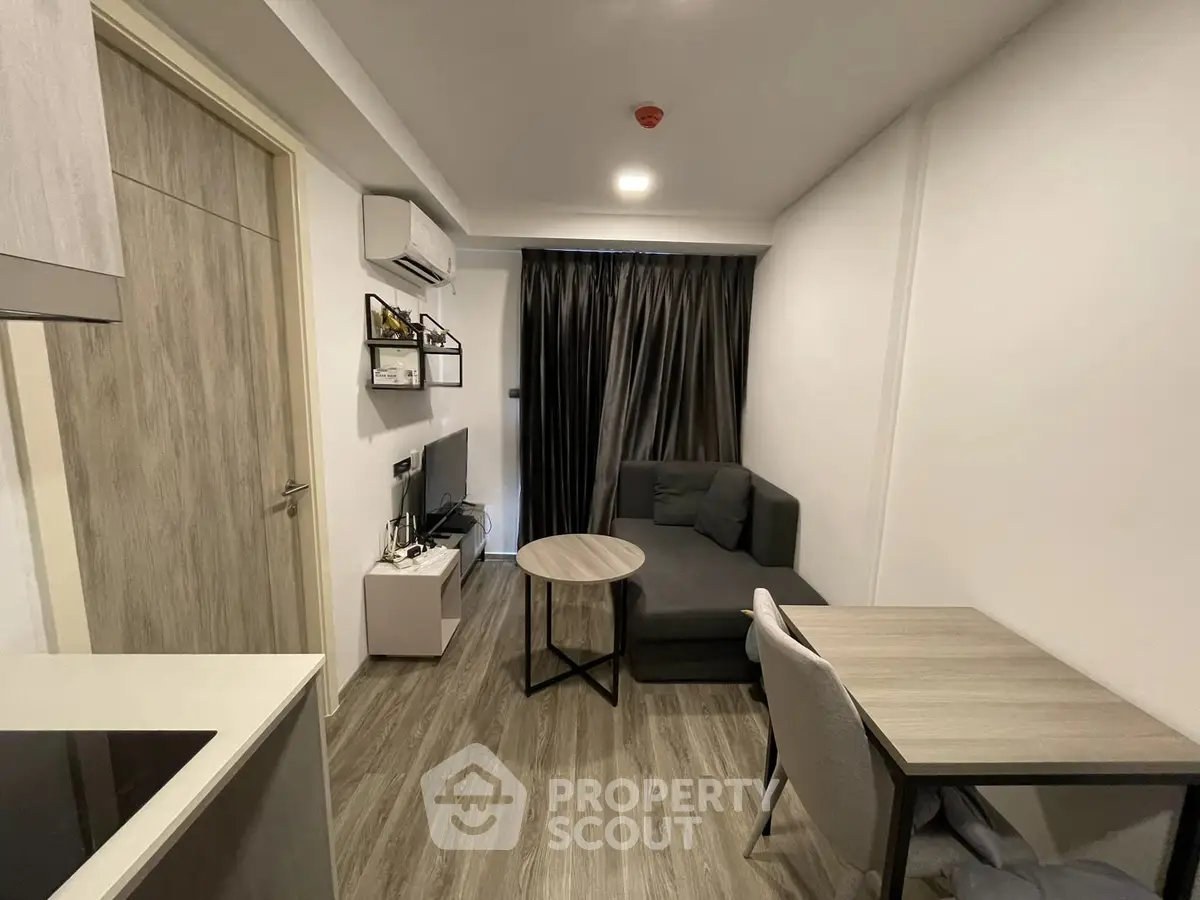 Modern living room with sleek furniture and stylish decor in a cozy apartment setting.