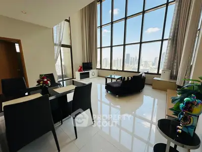 Luxurious high-rise living room with stunning city view and elegant decor.