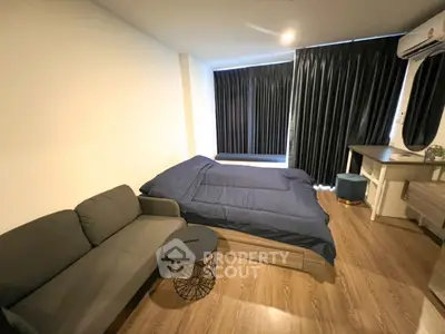 Cozy bedroom with modern furnishings and dark curtains in a stylish apartment.