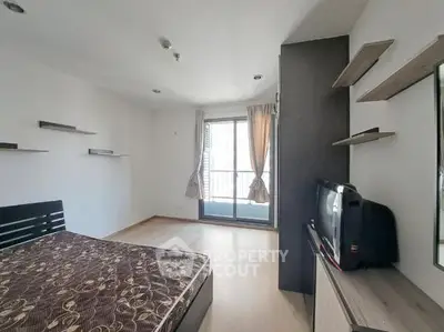 Spacious bedroom with modern decor and balcony access