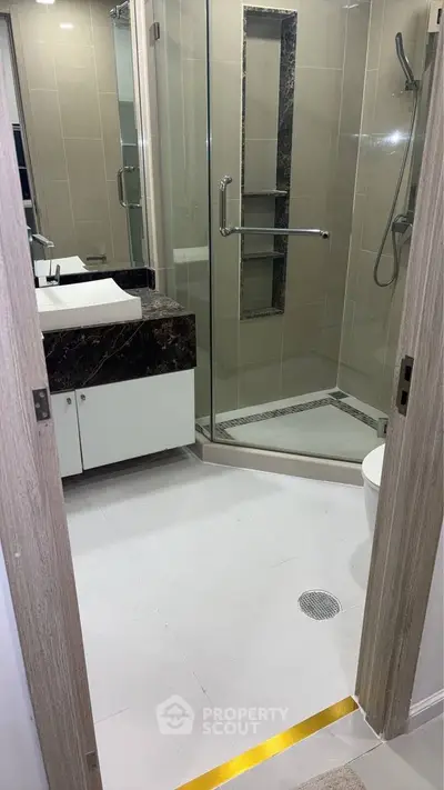 Modern bathroom with glass shower and elegant marble countertop
