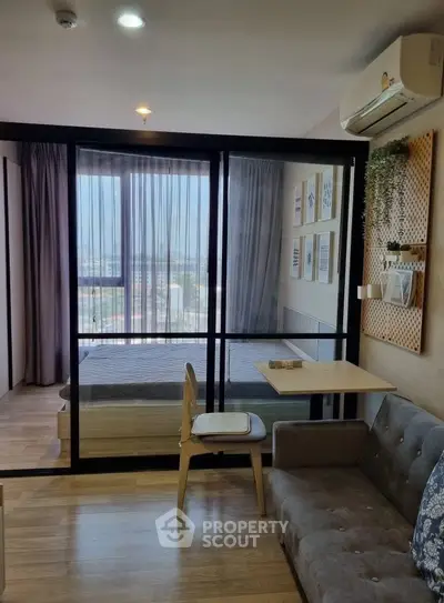 Modern studio apartment with glass partition, cozy living area, and scenic view.
