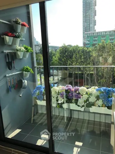 Charming balcony with vibrant flowers and city view, perfect for relaxation and urban gardening.
