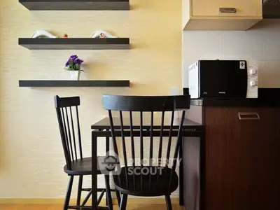 Charming kitchen nook with modern black chairs and sleek shelving, perfect for cozy dining.