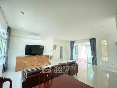 Spacious living room with modern decor and large windows for natural light.
