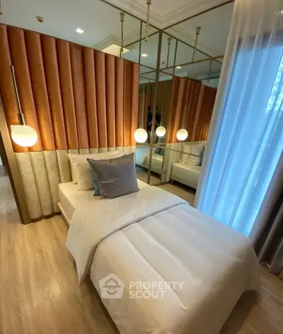 Luxurious bedroom with elegant design, featuring plush bedding and stylish lighting for a cozy ambiance.