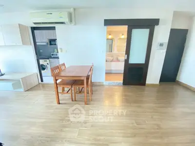 Spacious open-plan living area with modern appliances and wooden flooring