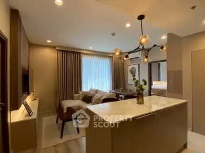 Modern open-layout living room with stylish lighting and cozy seating area