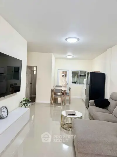 Spacious modern living room with sleek furniture and open layout, perfect for family gatherings.