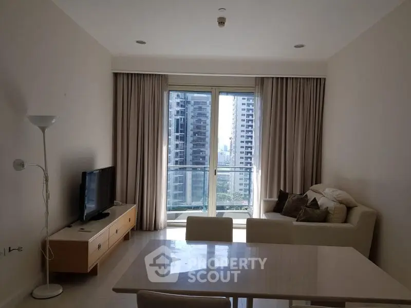 Modern living room with city view, stylish furniture, and natural light.