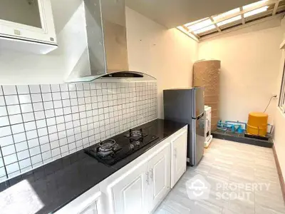 Modern kitchen with gas stove and sleek black countertop