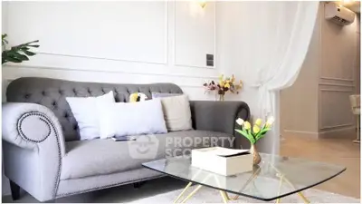 Elegant living room with plush gray sofa and modern glass coffee table