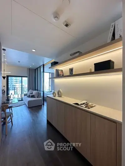 Modern living room with sleek design and city view, featuring stylish furniture and ambient lighting.