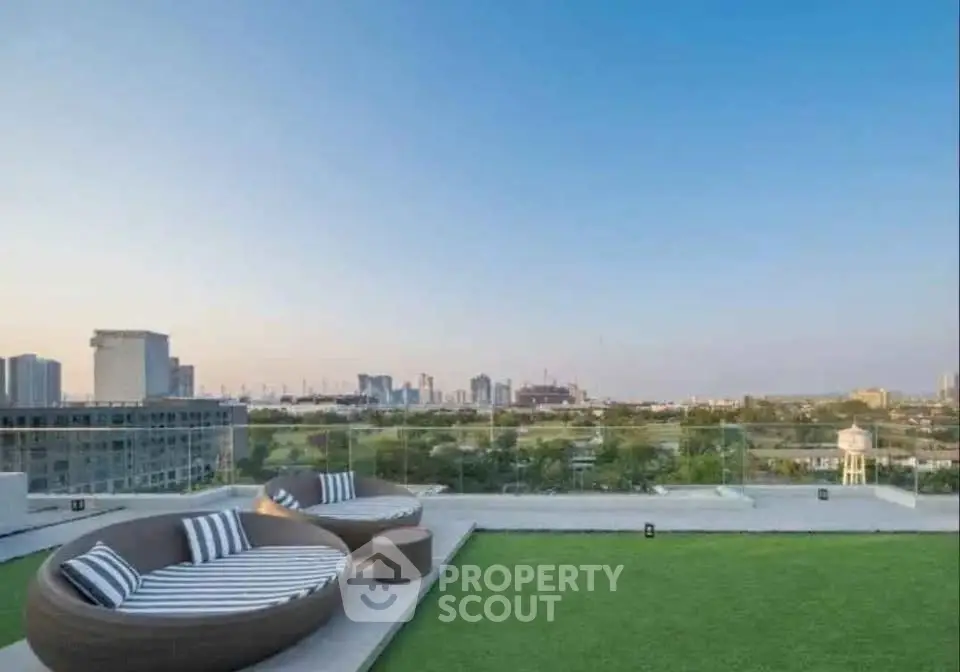 Luxurious rooftop with stunning city skyline view and modern outdoor seating.