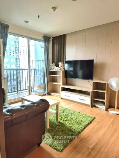 Modern living room with balcony view, featuring stylish furniture and natural light.