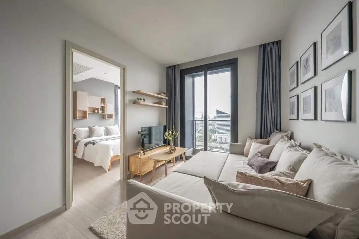 Modern living room with cozy sectional sofa and city view, connected to a stylish bedroom.