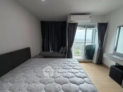 Modern bedroom with balcony view, featuring sleek design and ample natural light.