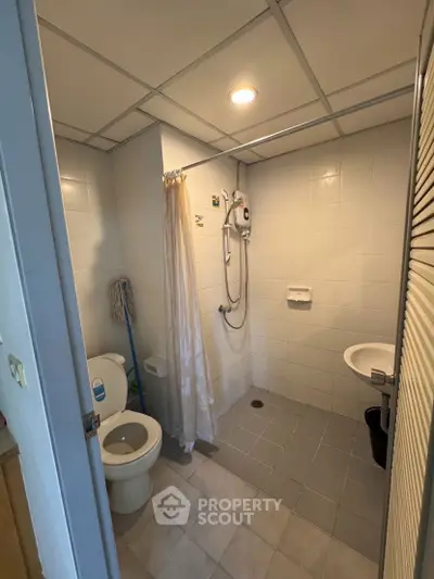 Compact bathroom with shower and toilet in modern apartment