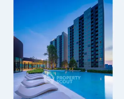 Luxurious high-rise apartment with stunning poolside view at sunset.