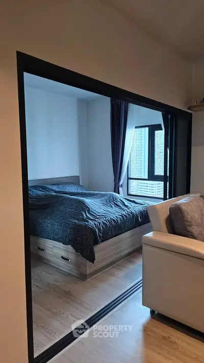Modern bedroom with large window and stylish decor in urban apartment