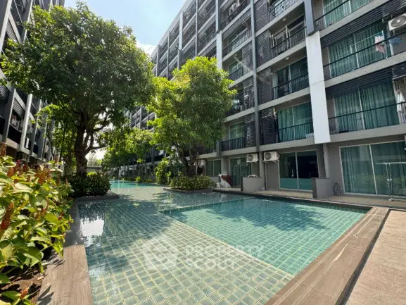 Modern apartment complex with inviting pool and lush greenery, perfect for urban living.