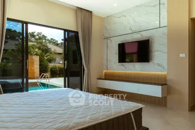 Luxurious bedroom with pool view, modern decor, and elegant lighting.