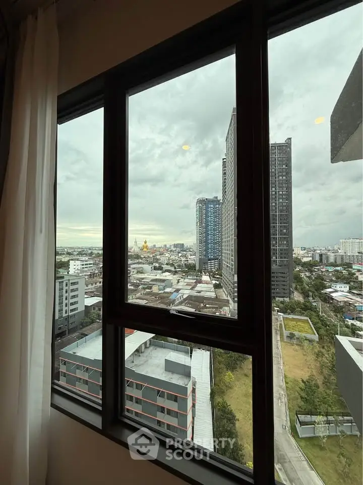 Stunning cityscape view from a high-rise apartment window, showcasing urban skyline and modern architecture.