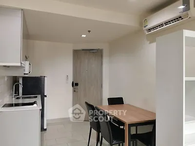 Modern kitchen and dining area with sleek appliances and minimalist design
