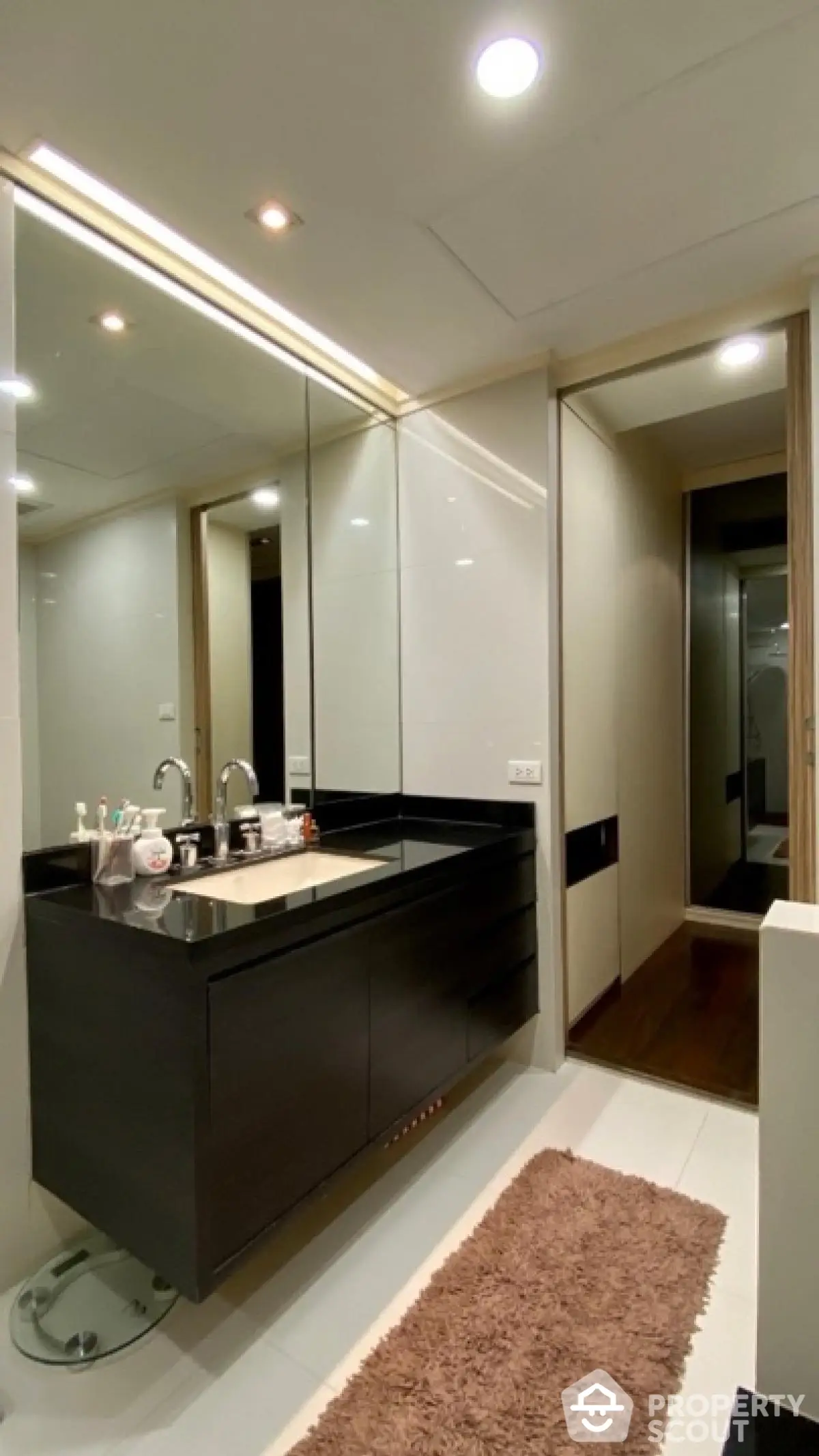 Modern bathroom with sleek black vanity and large mirror