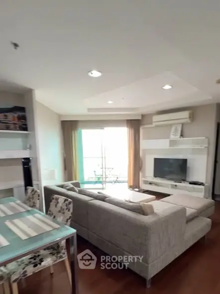 Spacious living room with modern decor and large windows for natural light.