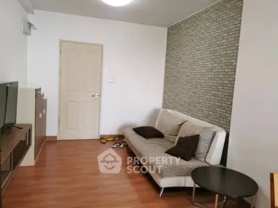 Modern living room with stylish sofa and brick accent wall