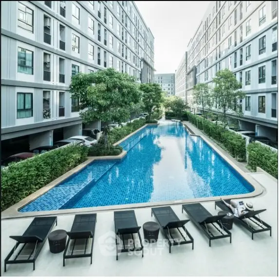 Luxurious apartment complex with a stunning outdoor pool and modern amenities.