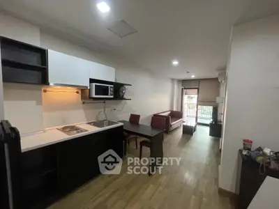 Modern open-layout kitchen and living room with sleek design and natural light.