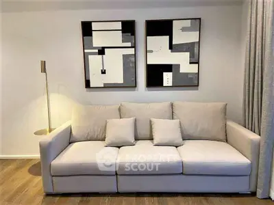 Stylish modern living room with elegant beige sofa and abstract art decor