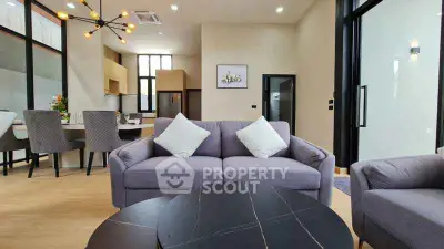 Modern living room with stylish furniture and open kitchen layout