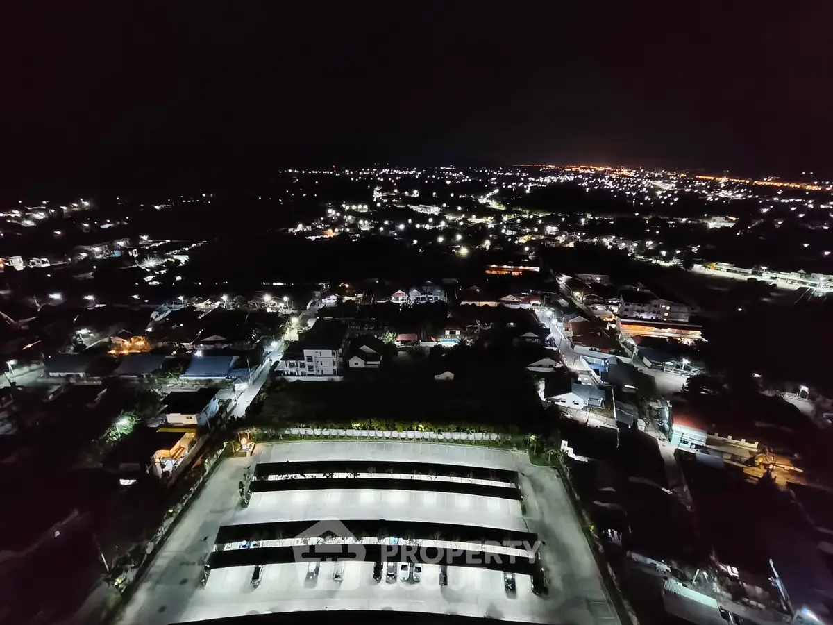 Stunning aerial night view of a cityscape with illuminated buildings and streets.