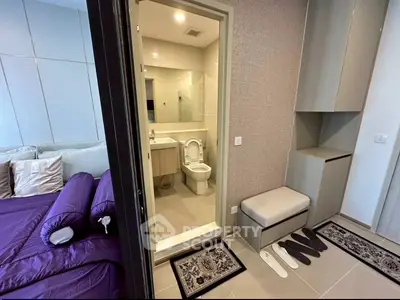 Modern bedroom with ensuite bathroom featuring sleek design and contemporary furnishings.