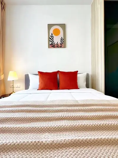 Cozy bedroom with stylish decor and warm lighting, perfect for relaxation.