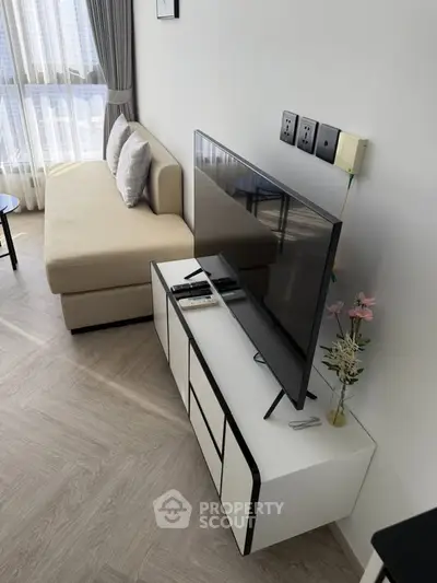 Modern living room with sleek TV stand and cozy beige sofa, perfect for relaxation and entertainment.
