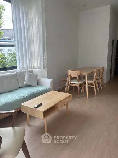 Bright and airy living room with modern furniture and large window view.