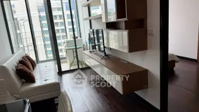 Modern living room with sleek furniture and large windows offering city views