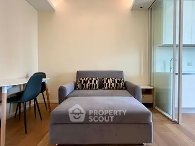 Modern living room with stylish sofa and dining area in open layout apartment.