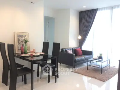 Modern living room with sleek black furniture and elegant decor