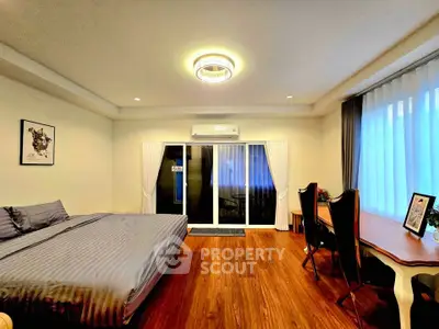 Spacious bedroom with elegant decor and natural light