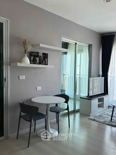 Modern living room with sleek furniture and balcony view