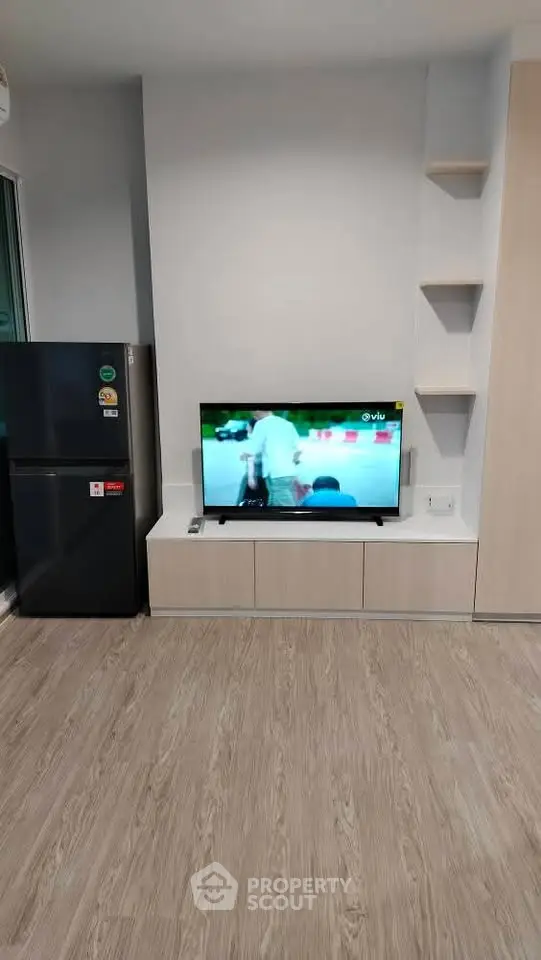 Modern living room with sleek TV setup and stylish flooring