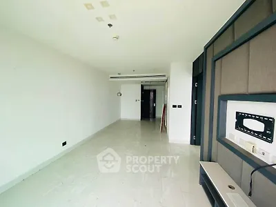 Spacious unfurnished living room with modern design and ample natural light.