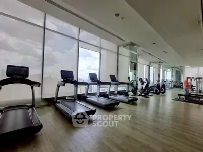Spacious modern gym with city view and state-of-the-art equipment